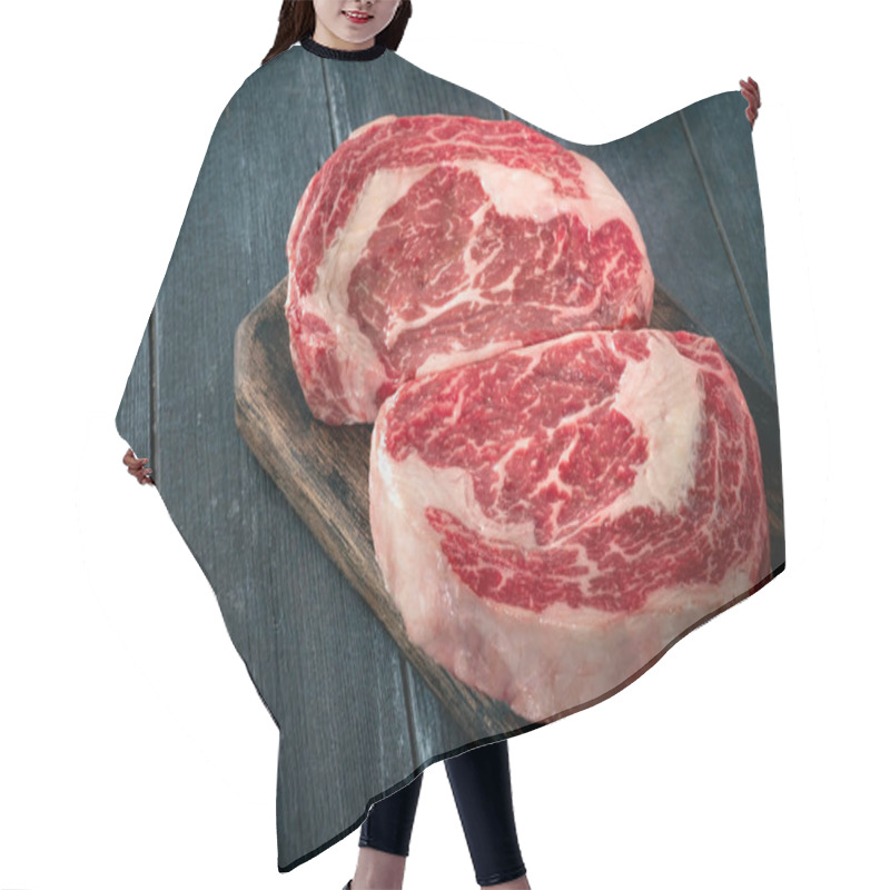 Personality  Perfect Raw Rib Eye Beef Steak On Black Wooden Background, Close-up Hair Cutting Cape