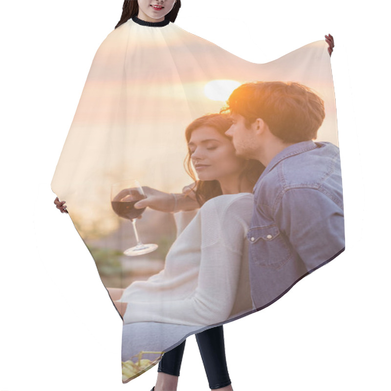 Personality  Selective Focus Of Man Embracing Girlfriend With Glass Of Wine Near Acoustic Guitar On Beach  Hair Cutting Cape