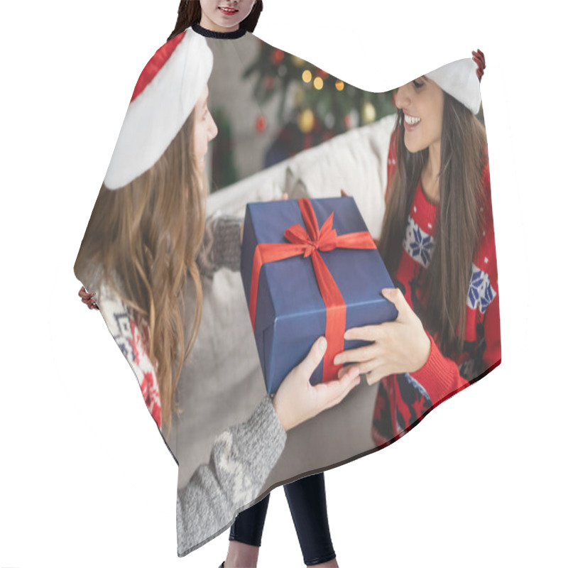 Personality  Blurred Woman In Santa Hat Giving Christmas Present To Girlfriend In Living Room  Hair Cutting Cape