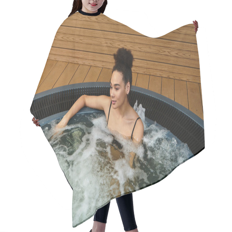 Personality  A Young African American Woman Relaxes In A Bubbling Hot Tub At A Peaceful Spa. Hair Cutting Cape