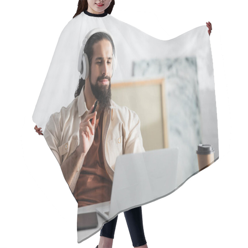 Personality  Latin Designer In Headphones Holding Stylus Near Blurred Graphic Tablet And Laptop Hair Cutting Cape