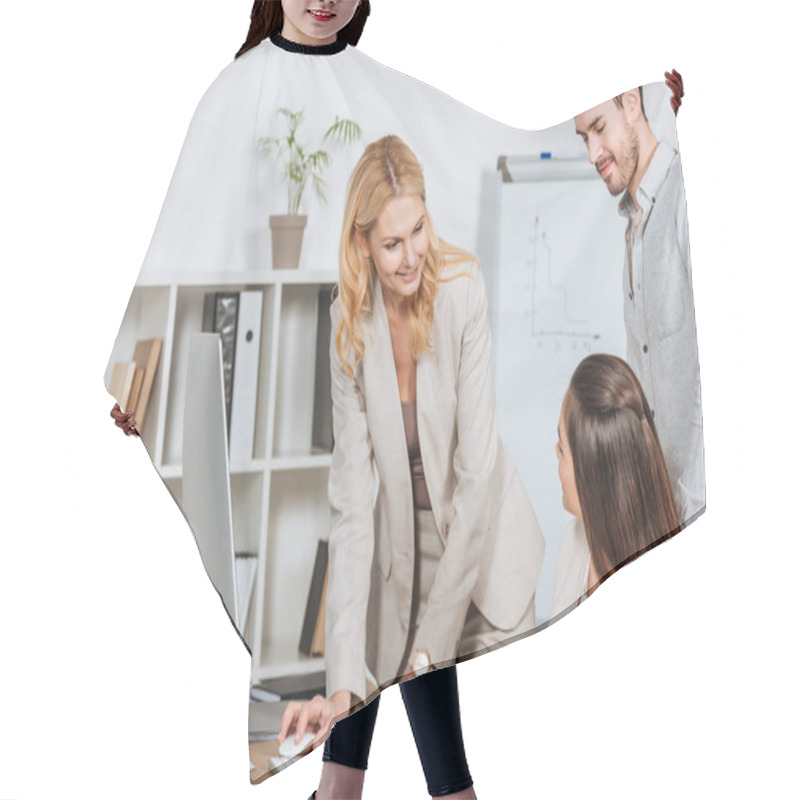 Personality  Smiling Mature Businesswoman Using Desktop Computer And Looking At Young Colleagues In Office Hair Cutting Cape