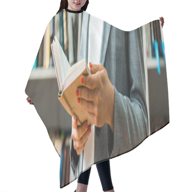 Personality  Panoramic Shot Of Woman Holding Book While Standing In Library  Hair Cutting Cape