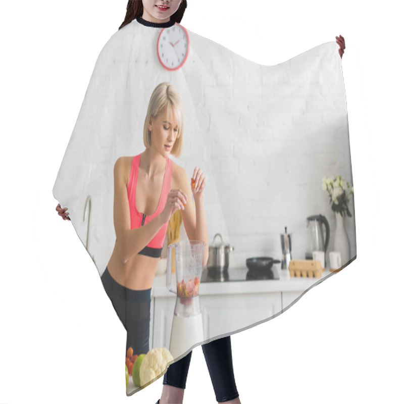 Personality  Beautiful Blonde Young Woman In Sportswear Putting Ingredients In Blender  Hair Cutting Cape