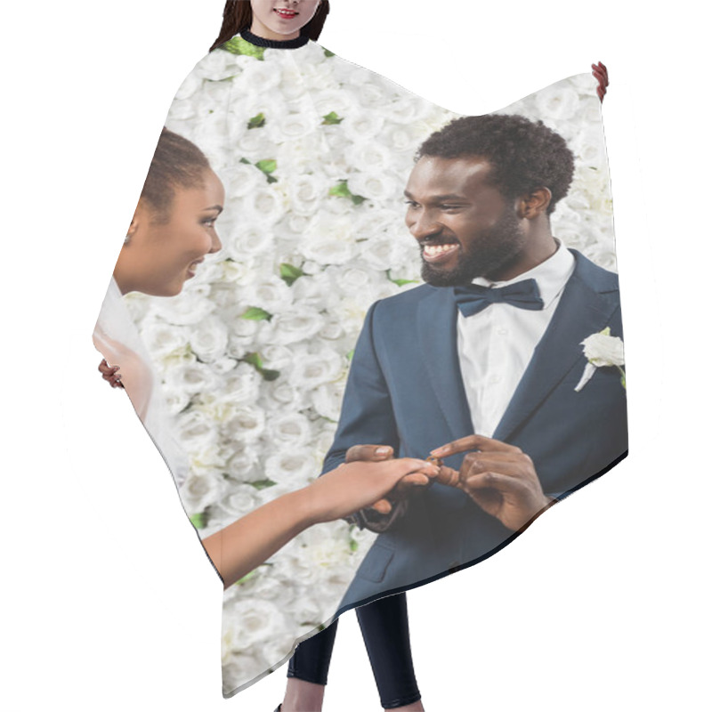 Personality  Happy African American Man Putting Wedding Ring On Finger Of Bride Near Flowers  Hair Cutting Cape