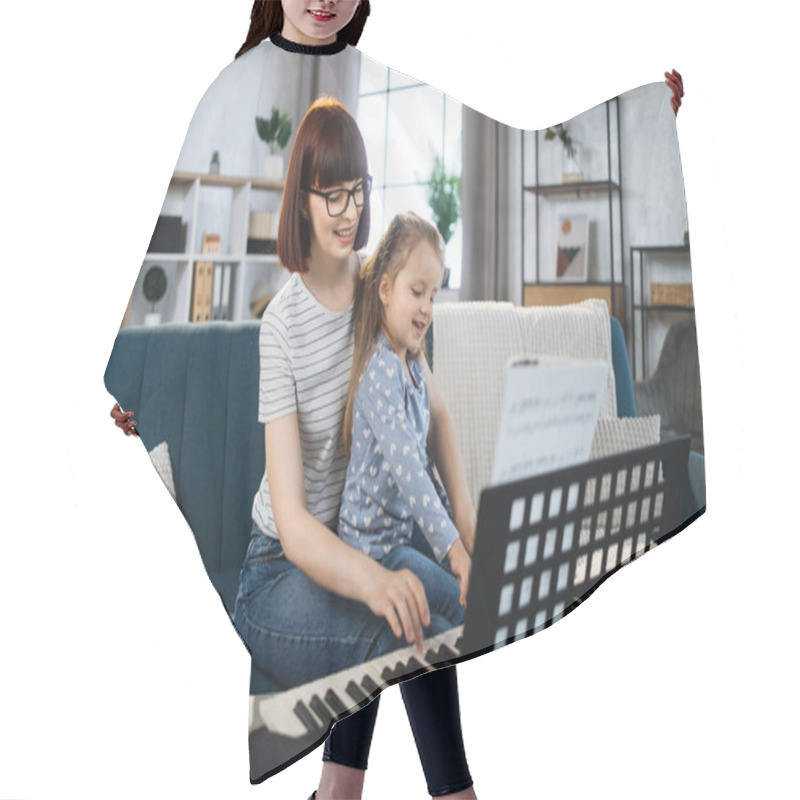 Personality  Portrait Of Caucasian Woman And Her Cute Little Daughter Learning To Play Piano At Home. Teacher Teaching Pretty Girl To Play Piano In Classroom. Hair Cutting Cape