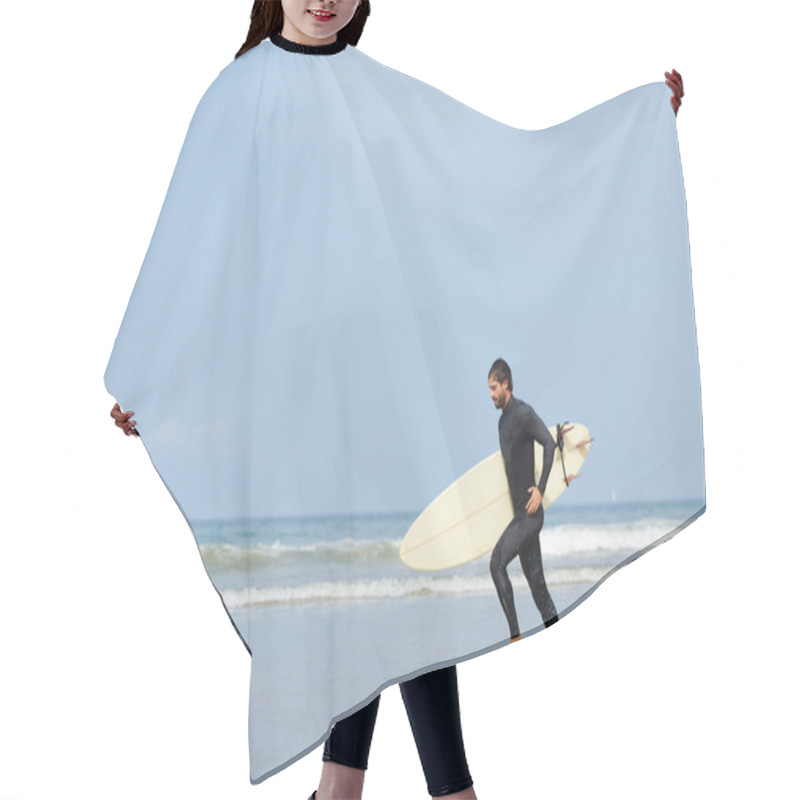 Personality  Young Attractive Surfer Runs With Surfboard Along The Shore, Cold Season Surfing At Ocean Beach, Professional Surfer Man Dressed In Wetsuit Ready To Surfing Runs To The Waves Hair Cutting Cape