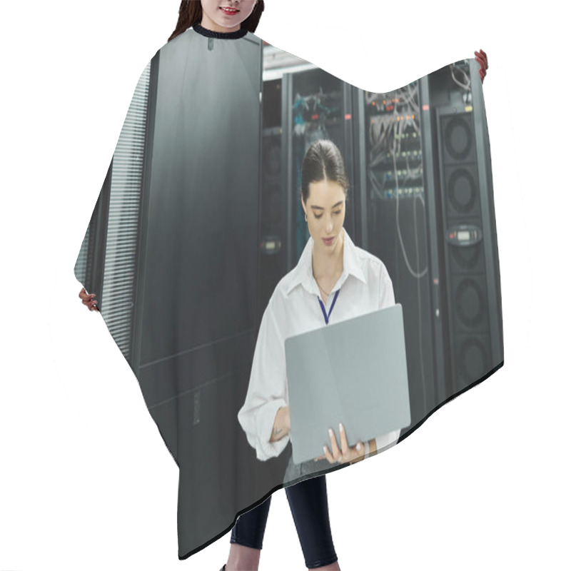 Personality  A Woman In A White Shirt Focuses On Her Laptop, Overseeing Server Operations In A Data Center. Hair Cutting Cape