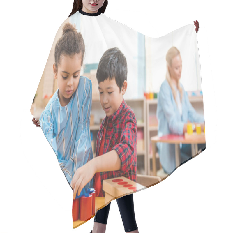 Personality  Selective Focus Of Kids Folding Educational Game With Teacher At Background In Montessori Class Hair Cutting Cape