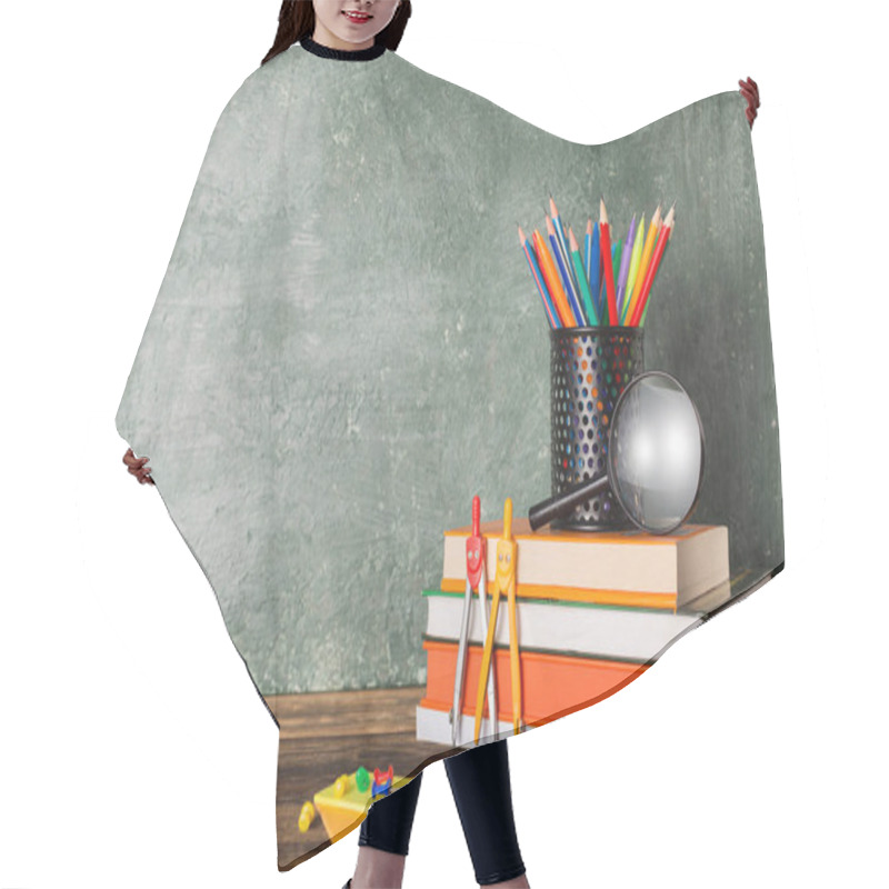 Personality  A Stack Of Books And Stationery On The Background Of The School Board. Education And Back To School Concept. Hair Cutting Cape