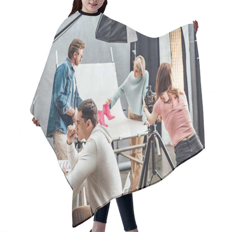 Personality  Selective Focus Of Handsome Man Looking At Computer Monitor Near Coworkers Working In Photo Studio  Hair Cutting Cape