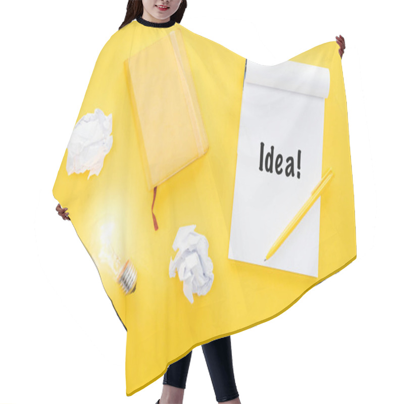 Personality  Notebook With 'idea' Word, Crumbled Paper Balls And Glowing Light Bulb, Having New Ideas Concept Hair Cutting Cape