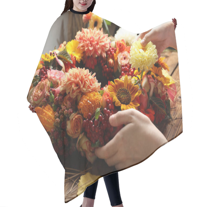 Personality  Florist Making Beautiful Autumnal Wreath With Flowers And Fruits At Wooden Table, Closeup Hair Cutting Cape