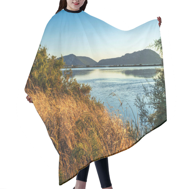 Personality  Sunset Light Illuminates Golden Grasses And Calm Waters Of Gialova Lagoon In Greece, With Distant Hills Creating A Serene Backdrop. Hair Cutting Cape