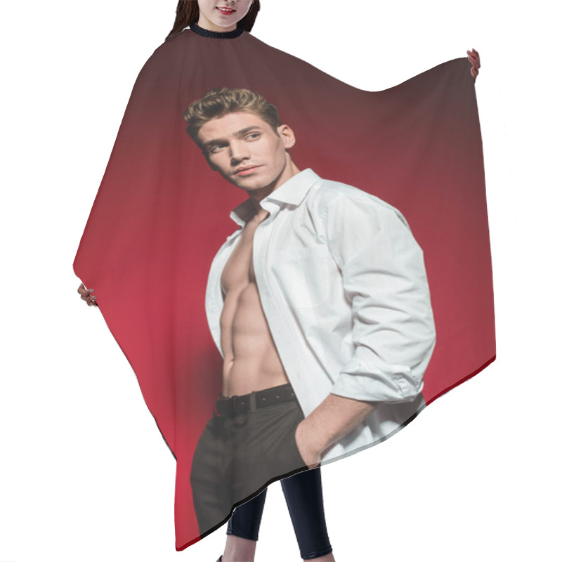 Personality  Sexy Young Elegant Man In Unbuttoned Shirt With Muscular Bare Torso And Hand In Pocket Looking Away On Red Background Hair Cutting Cape