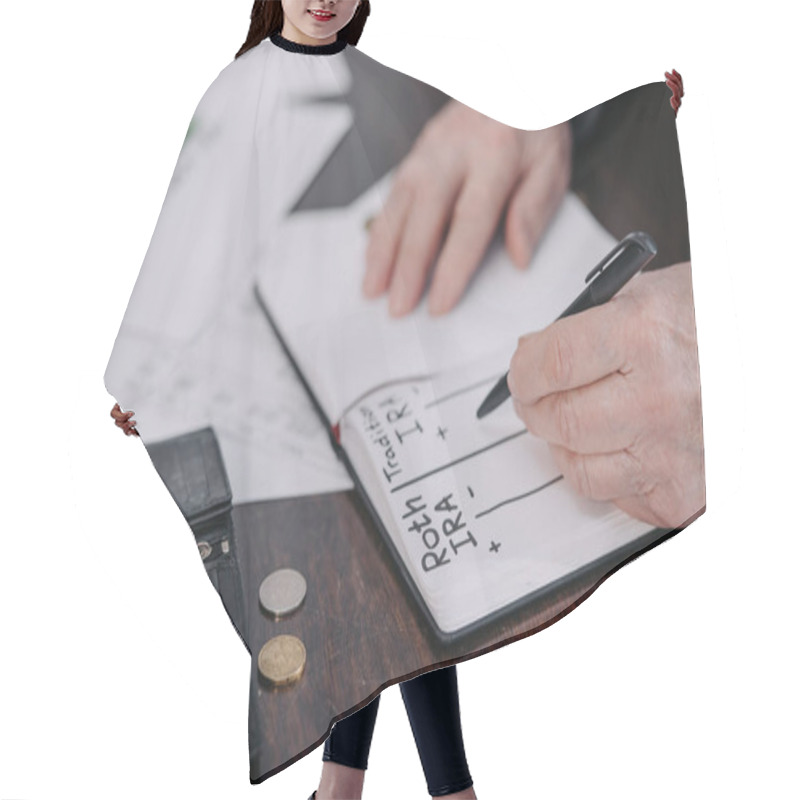 Personality  Cropped View Of Senior Woman Writing In Notebook With Roth Ira And Traditional Ira Words Hair Cutting Cape