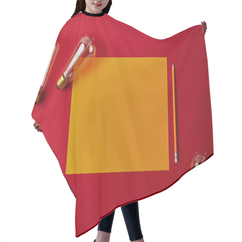 Personality  Top View Of Blank Yellow Paper With Pencil And Incandescent Lamps On Red Surface Hair Cutting Cape