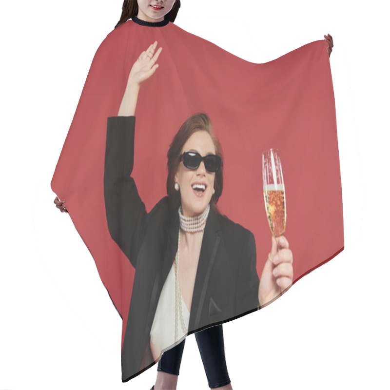 Personality  A Stylish Young Woman Joyfully Raises A Glass Against A Bright Backdrop. Hair Cutting Cape