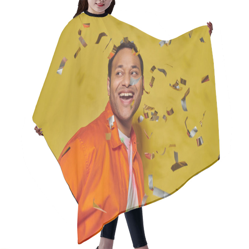 Personality  Cheerful Indian Man In Bright Orange Jacket Smiling Near Falling Confetti On Yellow Backdrop Hair Cutting Cape