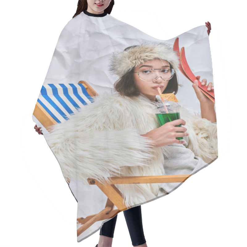 Personality  Asian Woman With Skis Drinking Hot Teddy Cocktail In Deck Chair On White Textured Backdrop Hair Cutting Cape