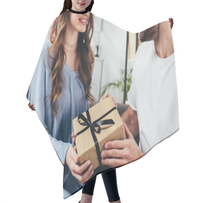 Personality  Cropped View Of Young Happy Couple Holding Gift Box With Ribbon Hair Cutting Cape