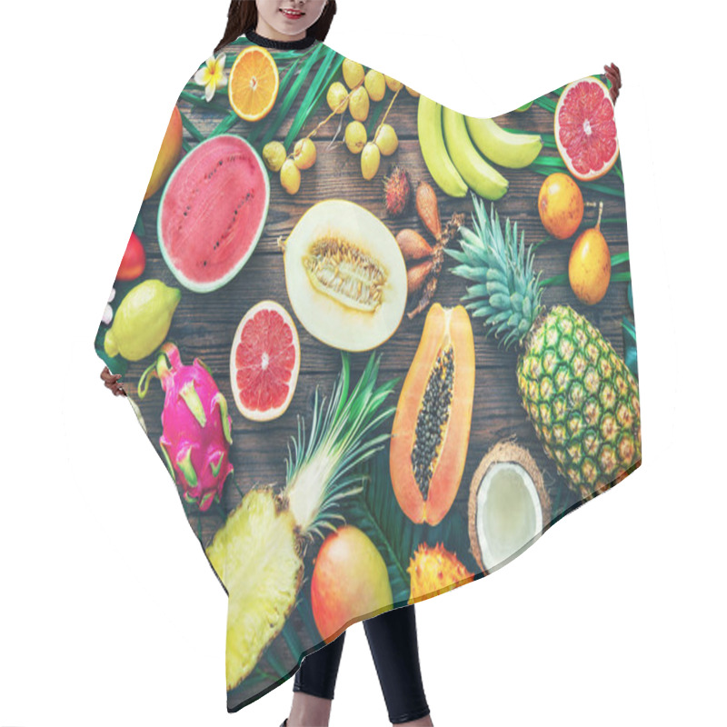 Personality  Assortment Of Tropical Fruits With Leaves Of Palm Trees And Exotic Plants On Dark Wooden Background. Top View Hair Cutting Cape