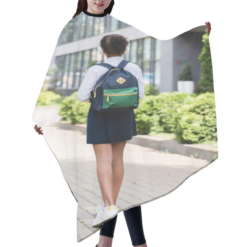 Personality  Back View Of African American Schoolgirl In Headphones Walking With Backpack Outdoors Hair Cutting Cape