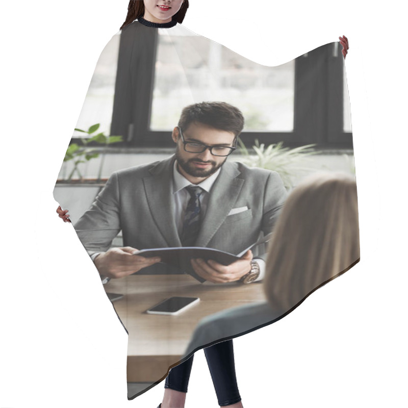 Personality  Businessman In Suit Holding Resume Near Blurred Woman During Job Interview In Office  Hair Cutting Cape