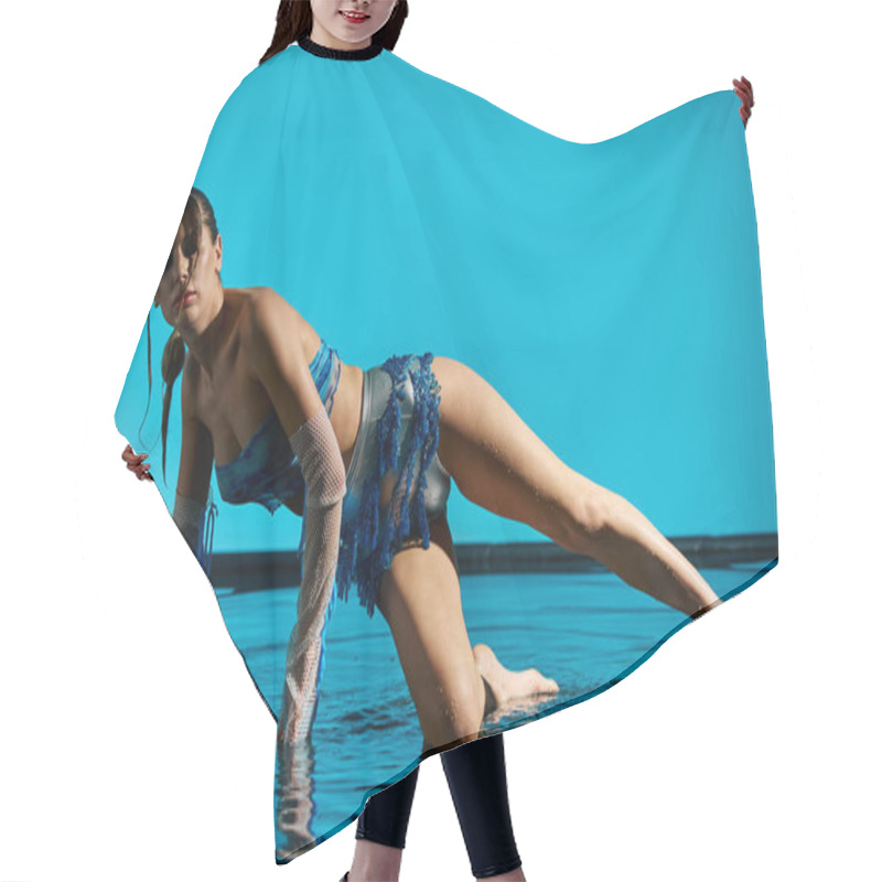 Personality  A Young Woman In A Crop Top And Stylish Attire Poses By The Edge Of A Pool, Creating Ripples In The Water. Hair Cutting Cape