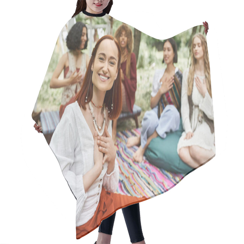 Personality  Smiling And Trendy Redhead Woman Sitting Near Blurred Multiethnic Friends In Retreat Center Hair Cutting Cape