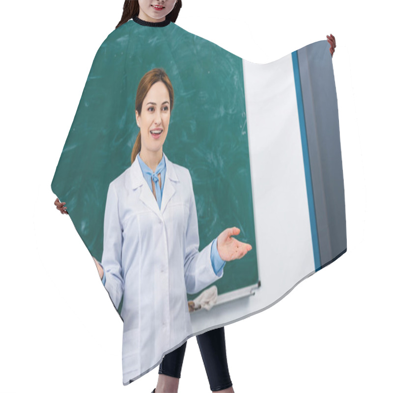 Personality  Smiling Chemistry Teacher In White Coat Explaining Lesson In Front Of Blackboard Hair Cutting Cape