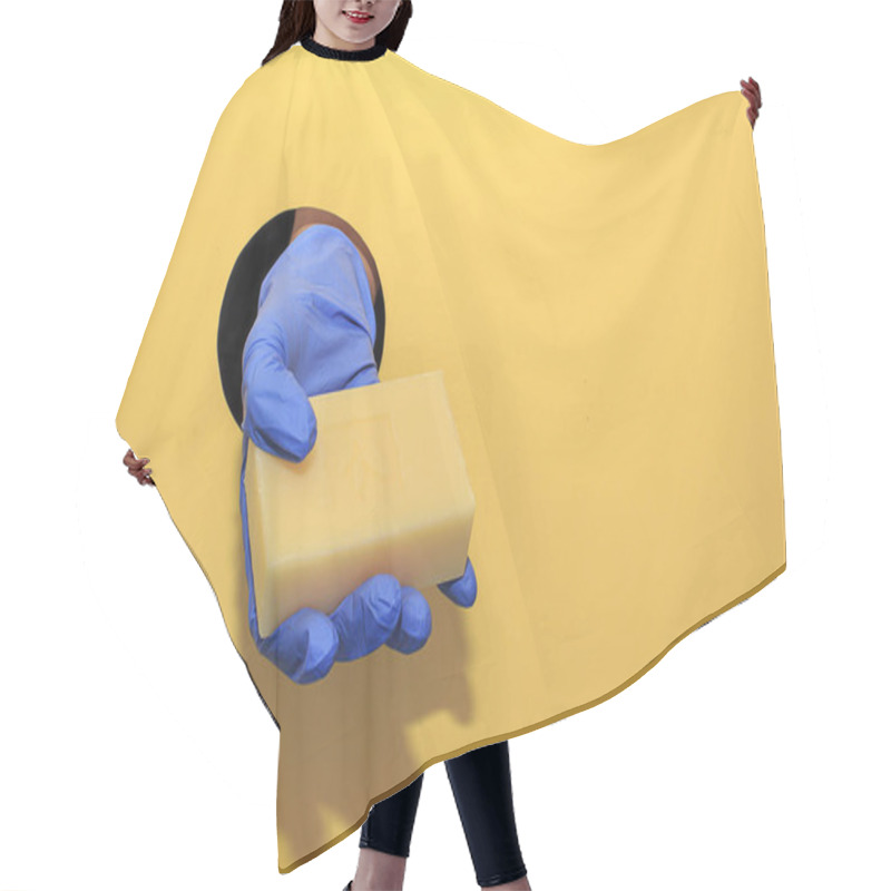 Personality  Womens Hand In A Blue Gloves Hold A Soap On A Yellow Background. Hand Hygiene And Protection During The Coronavirus Epidemic Hair Cutting Cape