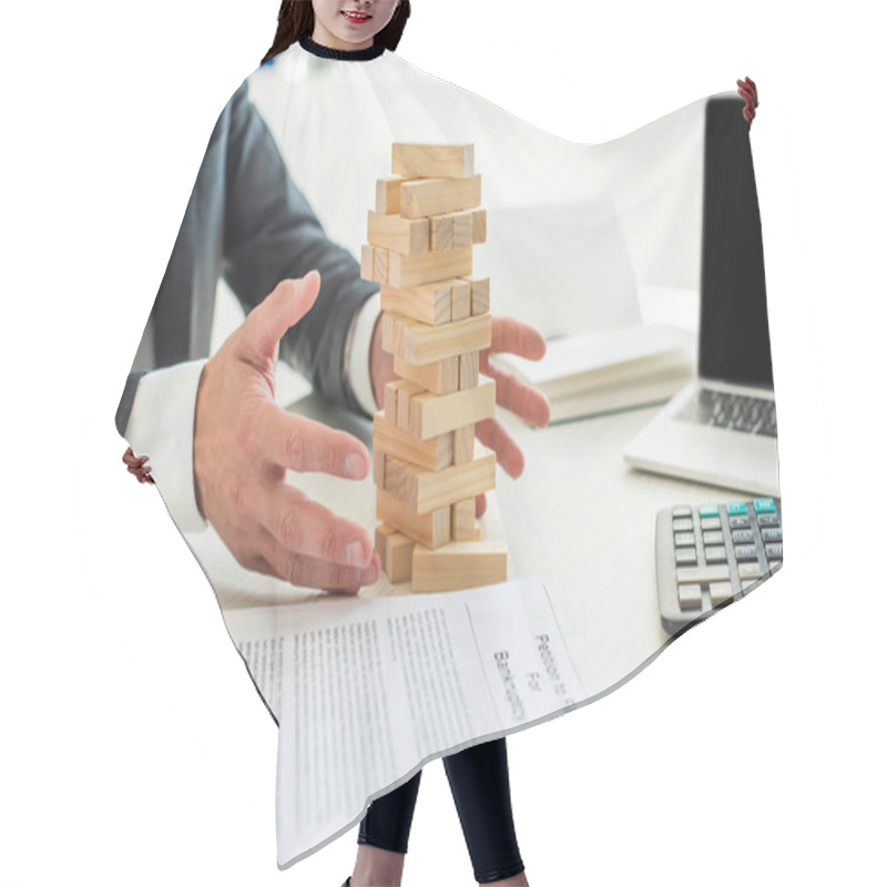 Personality  Cropped View Of Bankrupt With Hands Near Blocks Wood Tower Game, Sitting At Desk On Blurred Background Hair Cutting Cape