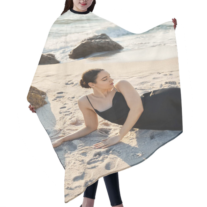 Personality  A Young Woman Reclines On A Sandy Beach, Wearing A Black Dress. Hair Cutting Cape