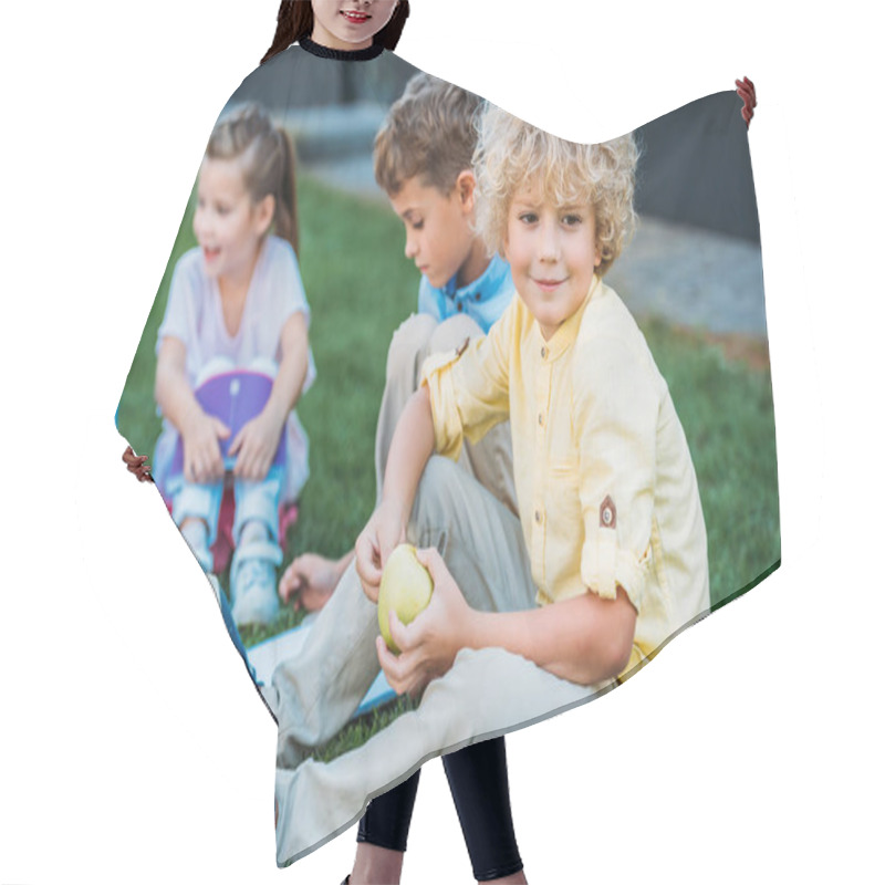 Personality  Adorable Curly Schoolboy With Apple Sitting On Grass With Classmates Hair Cutting Cape