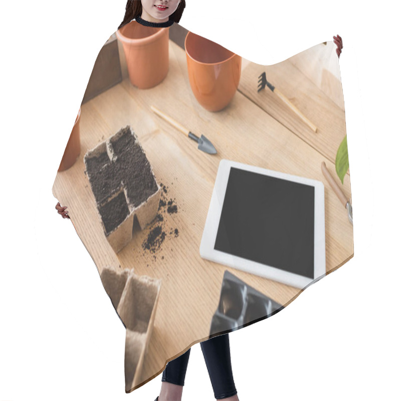 Personality  High Angle View Of Flowerpots Near Gardening Tools And Digital Tablet On Table In Flower Shop  Hair Cutting Cape