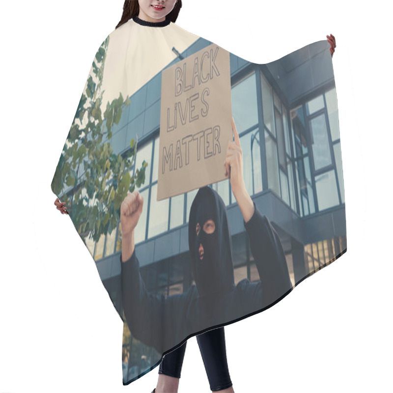 Personality  Young Activist In Balaclava Holding Placard With Black Lives Matter Lettering Near Modern Building Outside Hair Cutting Cape