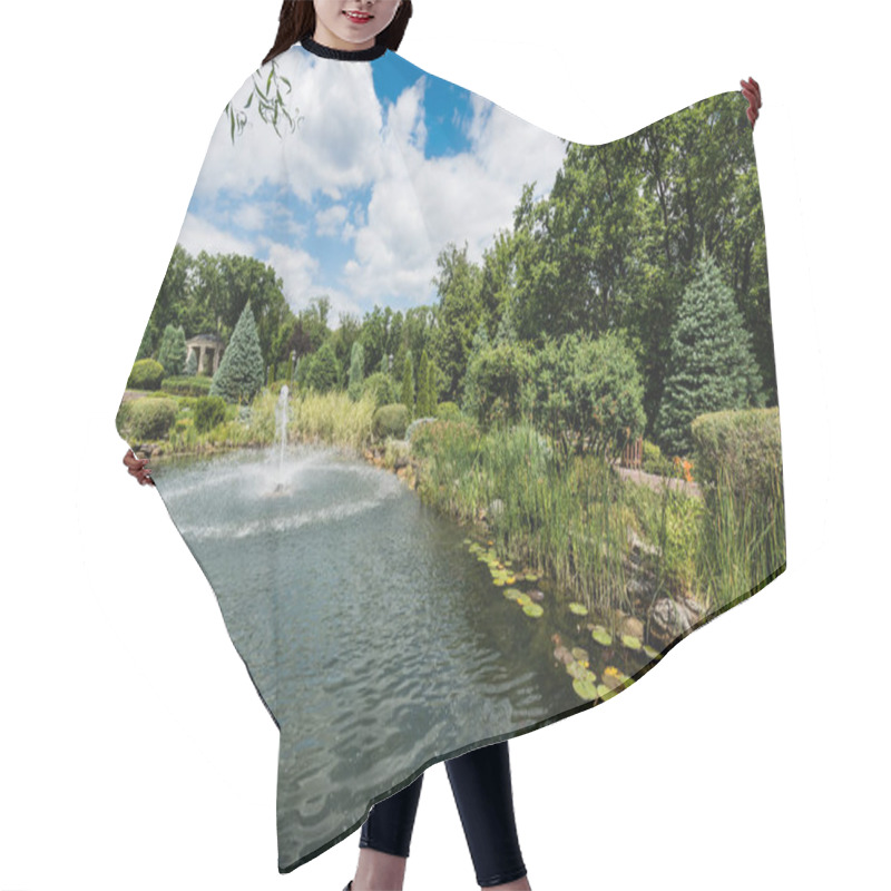 Personality  Water Splash Near Fountain In Lake Near Pines And Water Lily Leaves  Hair Cutting Cape