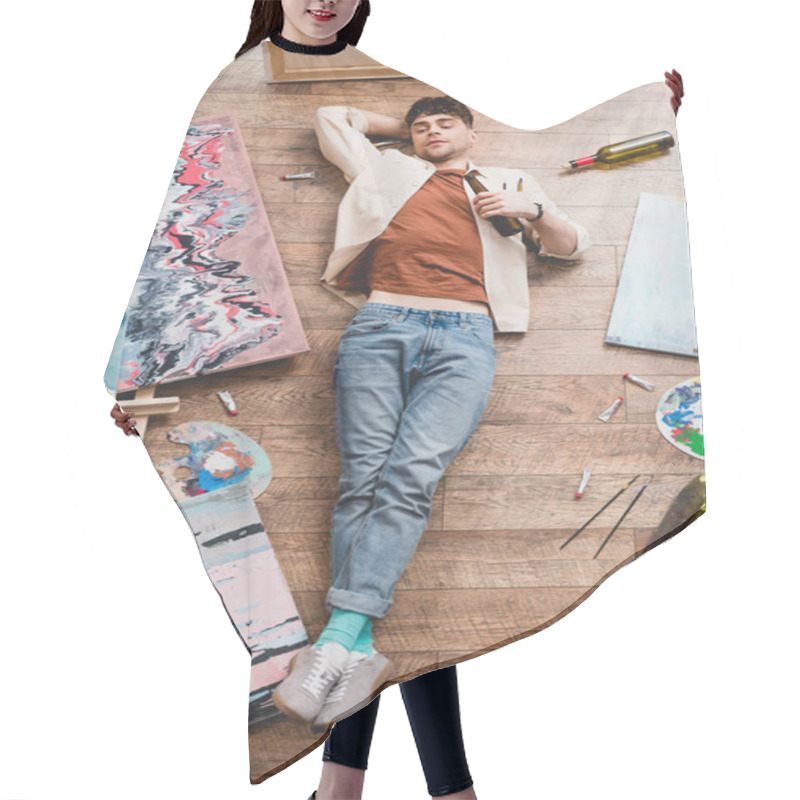 Personality  Overhead View Of Artist Lying On Floor And Holding Alcohol Bottle Hair Cutting Cape