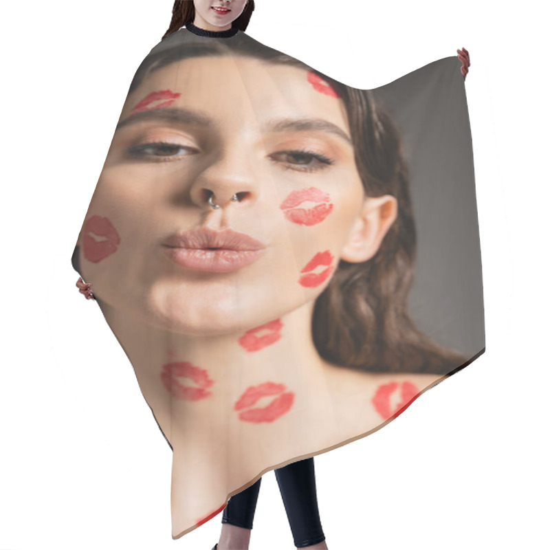 Personality  Portrait Of Pretty Woman With Makeup And Red Kiss Prints Pouting Lips While Looking At Camera Isolated On Grey Hair Cutting Cape