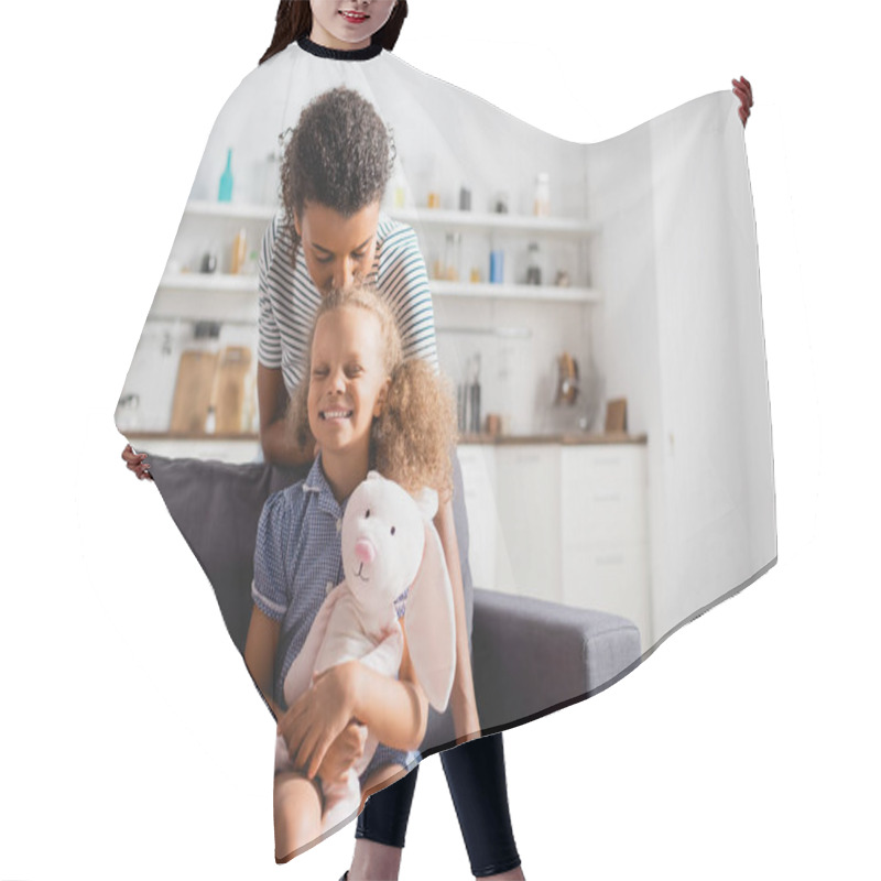 Personality  Young African American Woman Kissing Head Of Excited Daughter Holding Toy Bunny Hair Cutting Cape