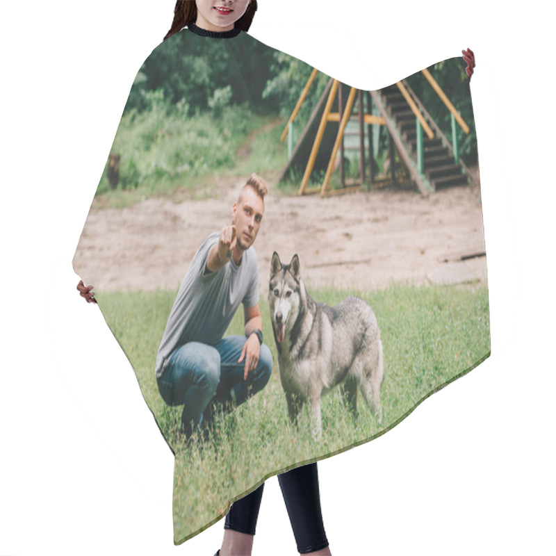 Personality  Young Man Showing Something To Husky Dog In Park Hair Cutting Cape