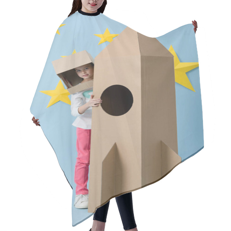 Personality  Full Length View Of Kid In Helmet Standing Near Cardboard Rocket On Blue Starry Background Hair Cutting Cape