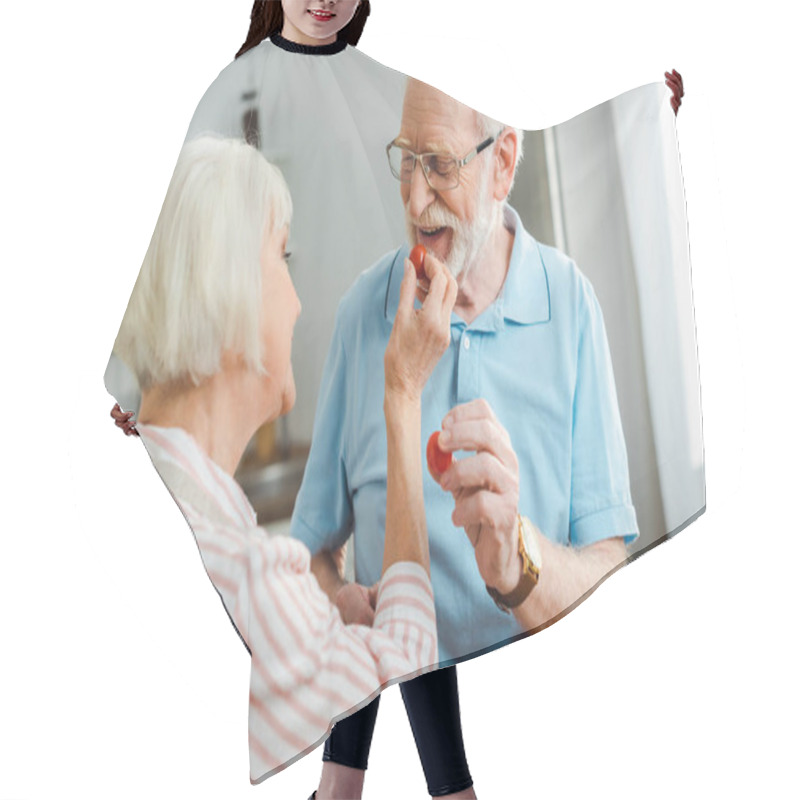 Personality  Selective Focus Of Senior Couple Holding Ripe Cherry Tomatoes In Kitchen Hair Cutting Cape