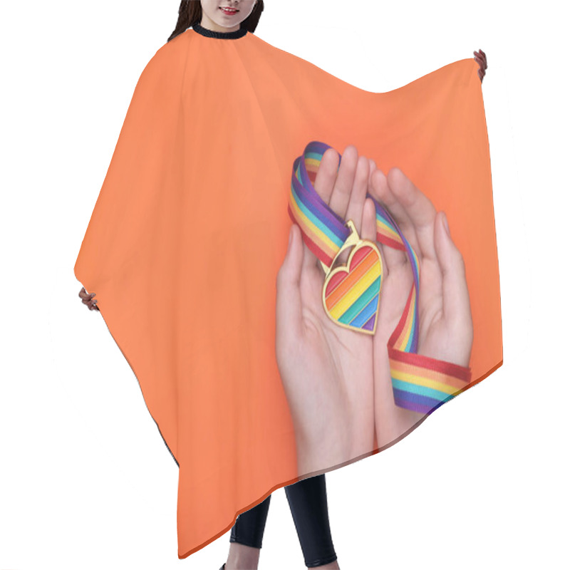 Personality  Woman Holding Rainbow Ribbon With Heart Shaped Pendant On Orange Background, Top View And Space For Text. LGBT Pride Hair Cutting Cape