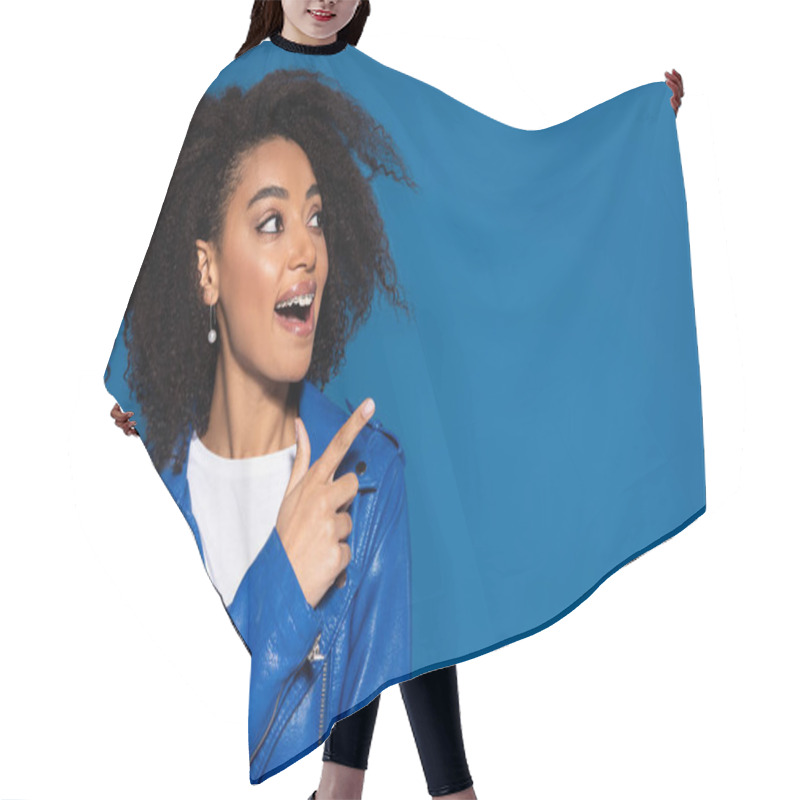 Personality  Happy African American Woman With Open Mouth Pointing With Finger Aside Isolated On Blue Hair Cutting Cape