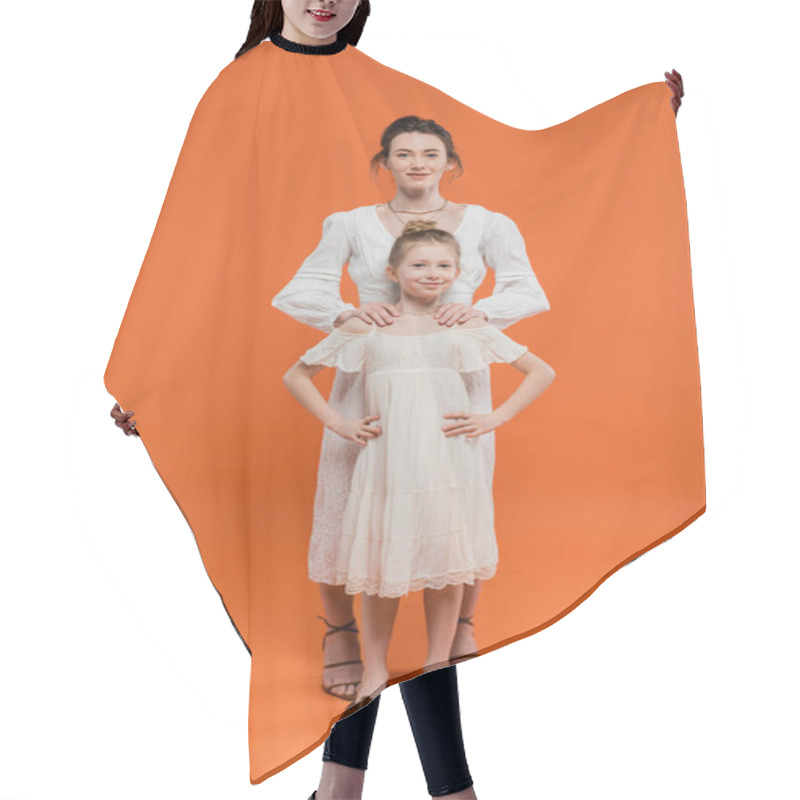 Personality  Modern Parenting, Summer Fashion, Woman Hugging Preteen Daughter And Standing Together In White Sun Dresses On Orange Background, Female Bonding, Fashionable Family, Summer Style  Hair Cutting Cape