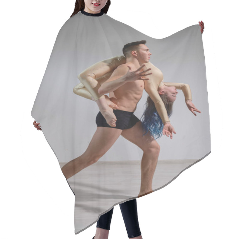 Personality  Heavy Circus Pose. A Young Man Holds A Flexible Woman. Two Acrobats Or Ballet Dancers Posing On A White Background. A Pair Of Gymnasts Perform Art. Hair Cutting Cape