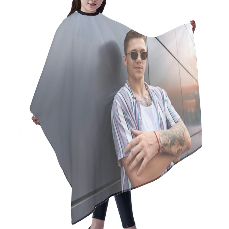 Personality  Young Man With Tattoos Stands In A Casual Pose, Showing Confidence And Style. Hair Cutting Cape