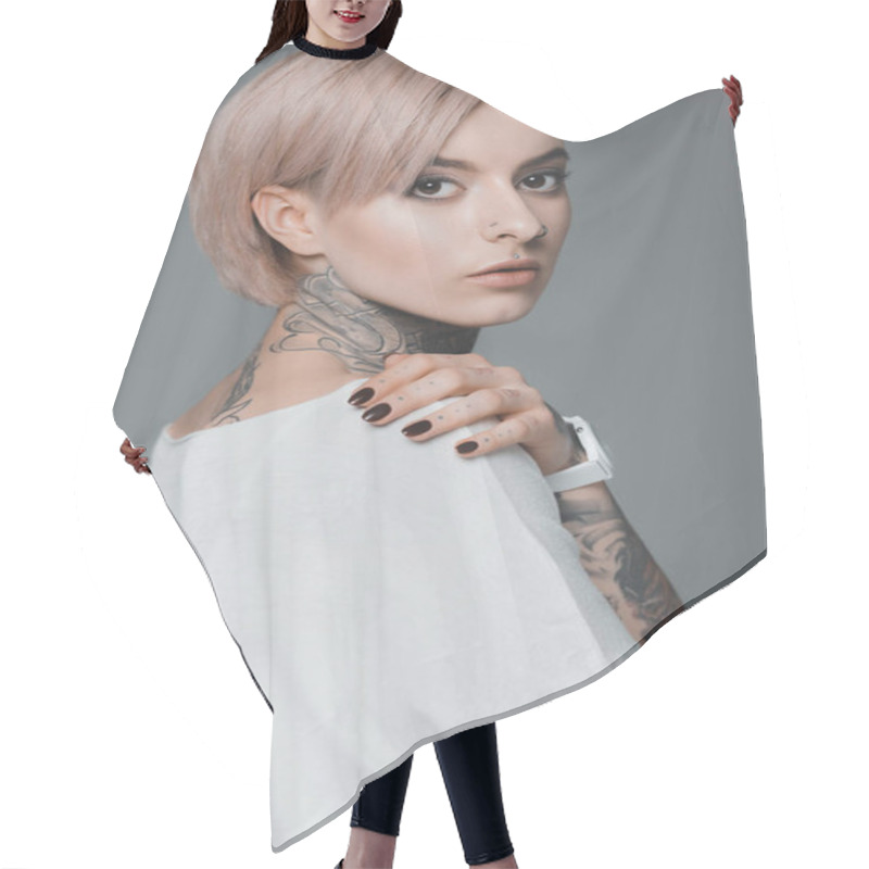 Personality  Portrait Of Beautiful Tattooed Girl In White T-shirt Looking At Camera Isolated On Grey Hair Cutting Cape